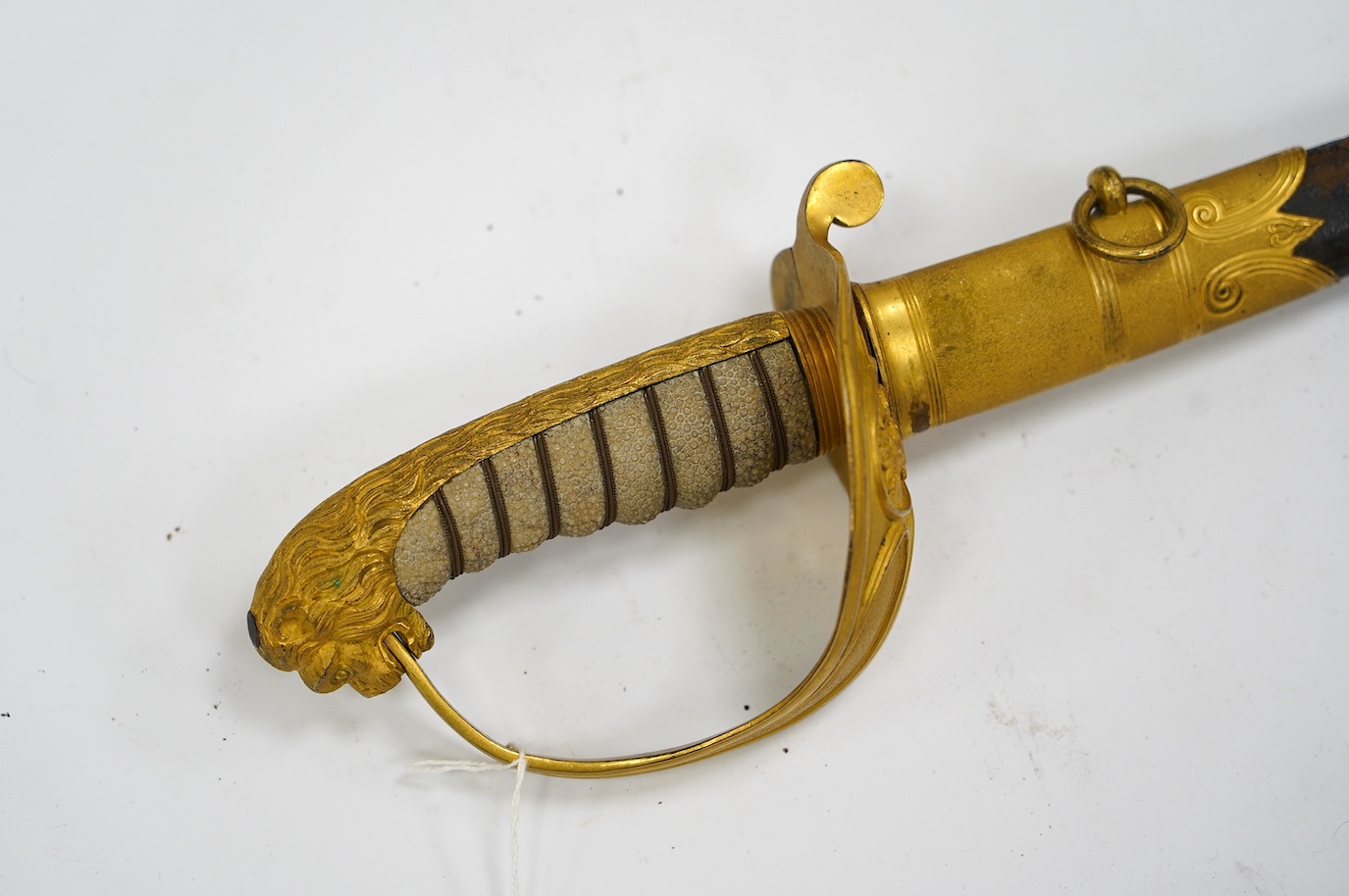 An East India Company naval officer's sword, blade by H. Wart, etched with East India Company device and foliage, regulation gilt, brass hilt with EIC device, white fish skin covered grip, in its leather scabbard with gi
